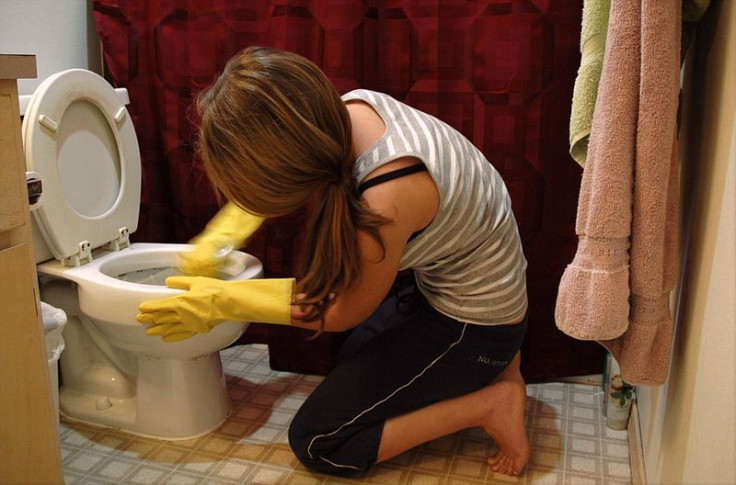 Woman cleaning toilet