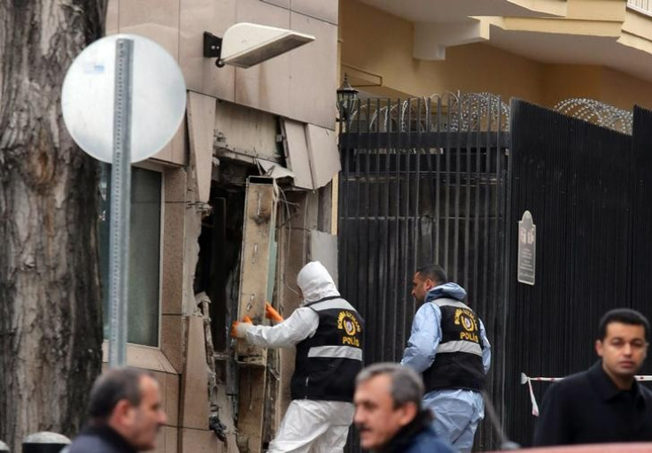 Turkish police bomb experts inspect the site of the Ankara US embassy bombing