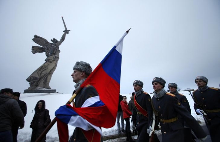 Russian soldiers march past the Mother Homeland statue