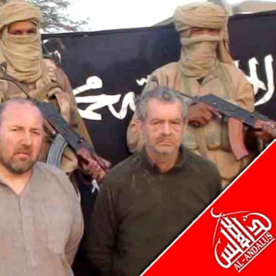 French nationals Philippe Verdon and Serge Lazarevic, who are being held hostage by Al Qaeda, are seen surrounded by masked men holding guns in an undisclosed location in Mali