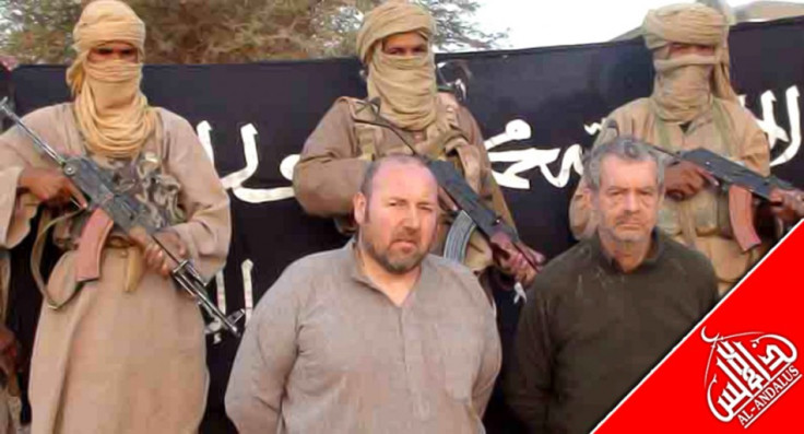 French nationals Philippe Verdon and Serge Lazarevic, who are being held hostage by Al Qaeda, are seen surrounded by masked men holding guns in an undisclosed location in Mali