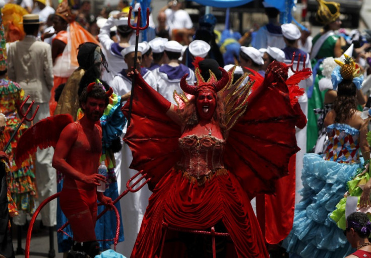 Revellers dressed as a devil parties in one of the “blocos” in preparation of the Rio de Janeiro Carnival (Reuters)
