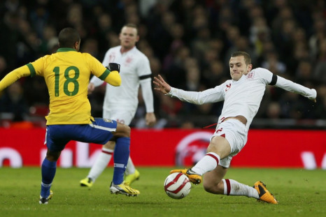 Wilshere battles for the ball with Brazil's Lucas