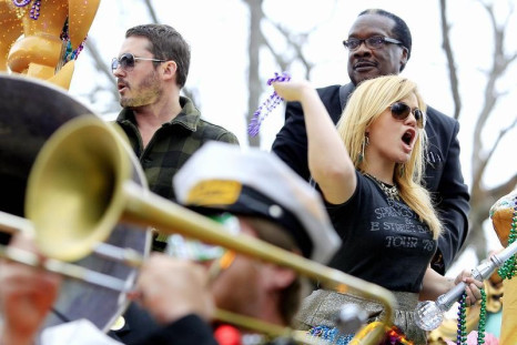 Singer Kelly Clarkson throws beads as she and members of the Krewe of Endymion parade down Orleans Avenue during the weekend before Mardi Gras in New Orleans, Louisiana February 9, 2013. Mardi Gras day will be celebrated on February 12, 2013.