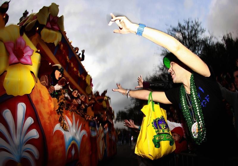 A reveler screams for beads as members of the Krewe of Endymion parade down Orleans Avenue during the weekend before Mardi Gras in New Orleans, Louisiana February 9, 2013. Mardi Gras day will be celebrated on February 12, 2013.