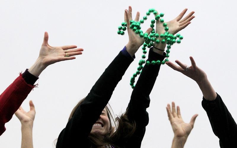 Revelers catch beads as members of the Krewe of Endymion parade down Orleans Avenue during the weekend before Mardi Gras in New Orleans, Louisiana February 9, 2013. Mardi Gras day will be celebrated on February 12, 2013.