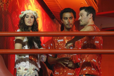 American actress Megan Fox (L), her husband Brian Austin Green (R) watch the annual carnival parade with a friend in Rio de Janeiro's Sambadrome, February 10, 2013.