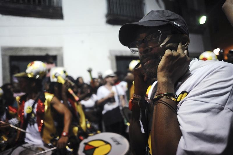American movie director Spike Lee covers his ears as he directs the filming of Afro-Brazilian cultural group Olodum as part of his documentary project titled Go Brazil Go, during a Carnival street party in Salvador da Bahia, February 8, 2013.