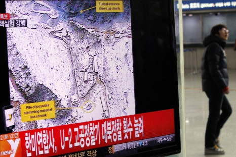 A passenger walks past a television report on North Korea's nuclear test at a railway station in Seoul - Reuters