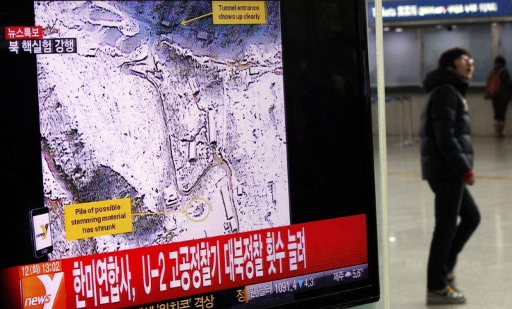 A passenger walks past a television report on North Korea's nuclear test at a railway station in Seoul - Reuters