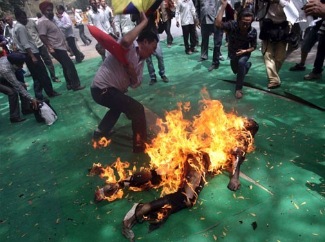 Tibetan activist and exile Jamphel Yeshi, 27, lies on the ground burning