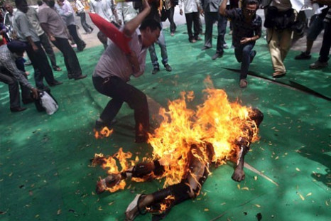 Tibetan activist and exile Jamphel Yeshi, 27, lies on the ground burning