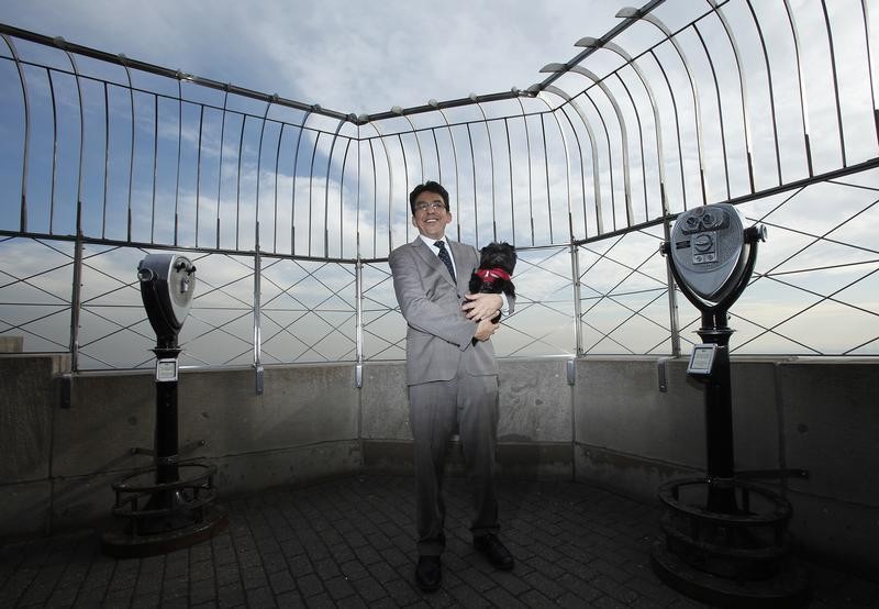 Handler Ernesto Lara holds Banana Joe, an Affenpinscher, on top of the Empire State Building following his Best in Show win last night at the 137th Westminster Kennel Club Dog Show, in New York February 13, 2013.