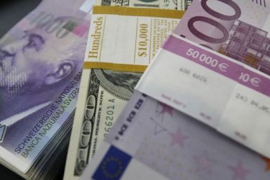 Stacks of Swiss franc, Euro and dollar banknotes