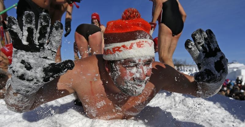 A man plays in the snow during the snow bath at the Quebec Winter Carnival on the Plains of Abraham in Quebec City, February 16, 2013.