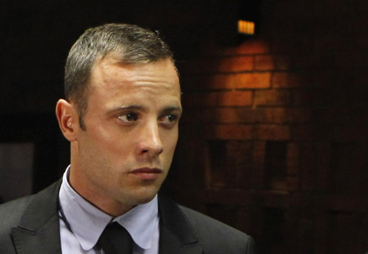 Oscar Pistorius stands in the dock during a break in court proceedings at the Pretoria Magistrates court (Reuters)