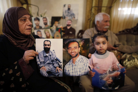 Layla al-Issawi holds a picture of her son Samer, who has been on hunger strike for 209 days while being held in an Israeli prison, at her home in the East Jerusalem neighbourhood of Issawiya February 17, 2013. (Photo: Reuters)