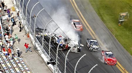 A car ploughs into the fence during the NASCAR Daytona 2013. A car ploughs into the fence during the NASCAR Daytona 2013.