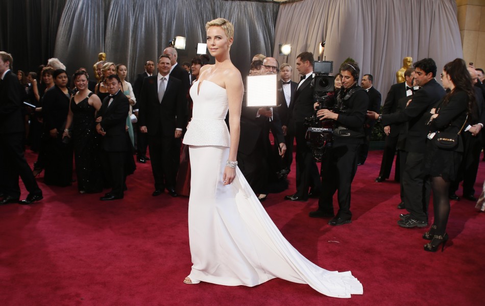 Actress Charlize Theron wearing white Dior Haute Couture column gown arrives at the 85th Academy Awards in Hollywood, California February 24, 2013.