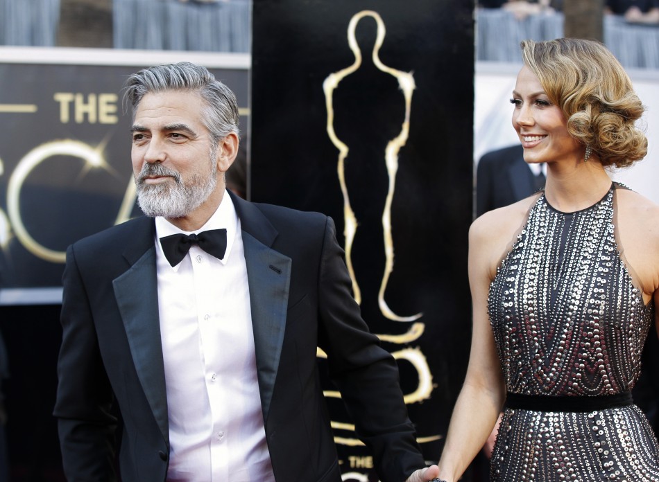 George Clooney, producer of best picture nominated film Argo, arrives at the 85th Academy Awards with his girlfriend Stacy Keibler, in Hollywood, California February 24, 2013.