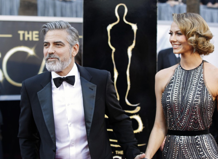 George Clooney, producer of best picture nominated film "Argo", arrives at the 85th Academy Awards with his girlfriend Stacy Keibler, in Hollywood, California February 24, 2013.