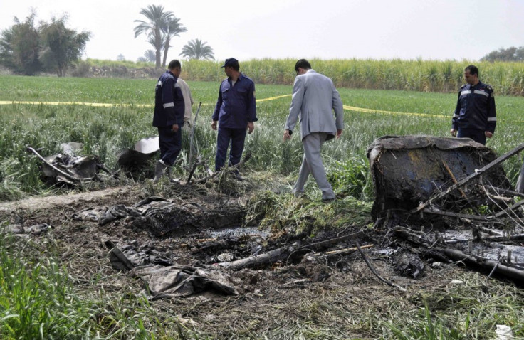 Police and rescue officials check the wreckage of a hot air balloon that crashed in Luxor (Reuters)
