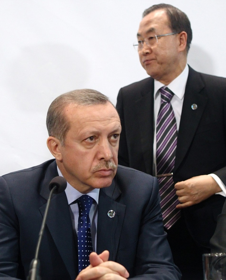U.N. Secretary General Ban Ki-moon (R) passes Turkey's Prime Minister Tayyip Erdogan as he leaves a news conference after the opening session of the fifth United Nations Alliance of Civilizations (UNAOC) Forum in Vienna