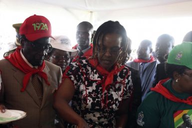 Zimbabwe's President Robert Mugabe looks at his wife Grace cutting a cake during an event marking his 89th birthday at Chipadze stadium in Bindura, about 90 km (56 miles) north of the capital Harare March 2, 2013. Addressing a rally to mark his 89th