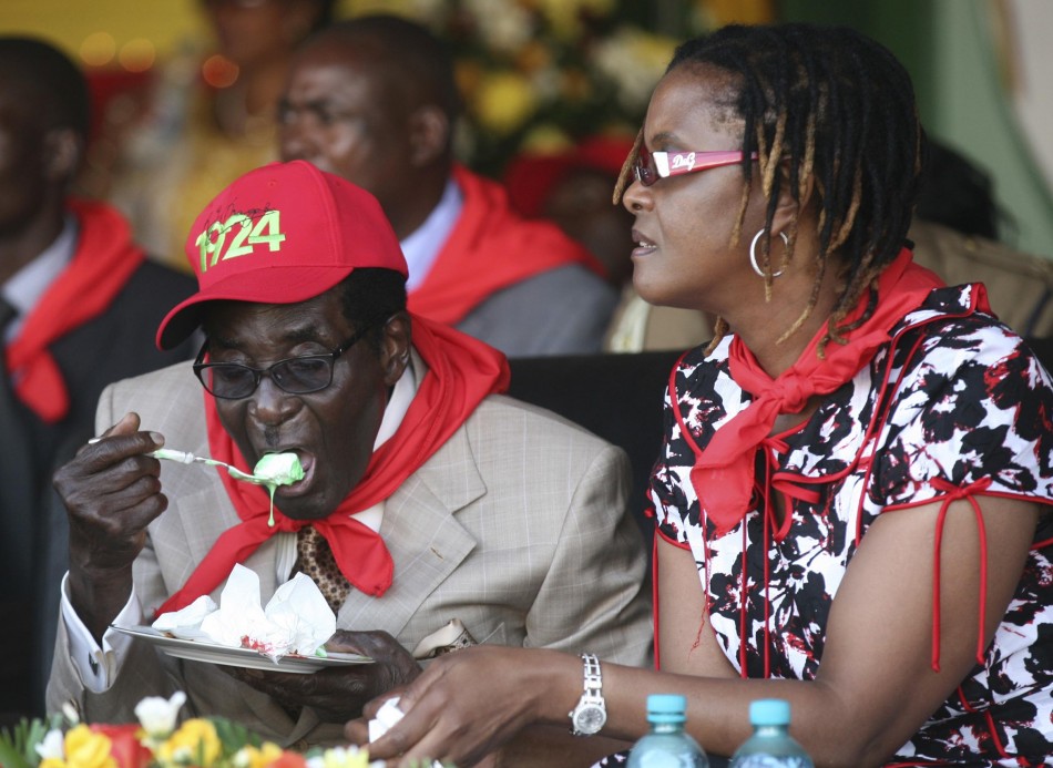 Zimbabwes President Robert Mugabe eats cake next to his wife Grace during an event marking his 89th birthday at Chipadze stadium in Bindura, about 90 km 56 miles north of the capital Harare March 2, 2013. Addressing a rally to mark his 89th birthd