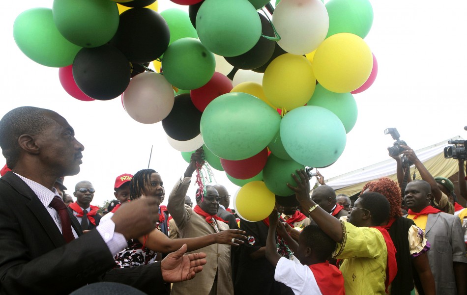 Zimbabwes President Robert Mugabe C releases balloons as he celebrates his 89th birthday at Chipadze stadium in Bindura, about 90 km 56 miles north of the capital Harare, March 2, 2013.