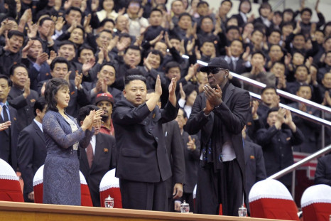 North Korean leader Kim Jong-Un (C), his wife Ri Sol-Ju (L) and former NBA basketball player Dennis Rodman clap during an exhibition basketball game in Pyongyang
