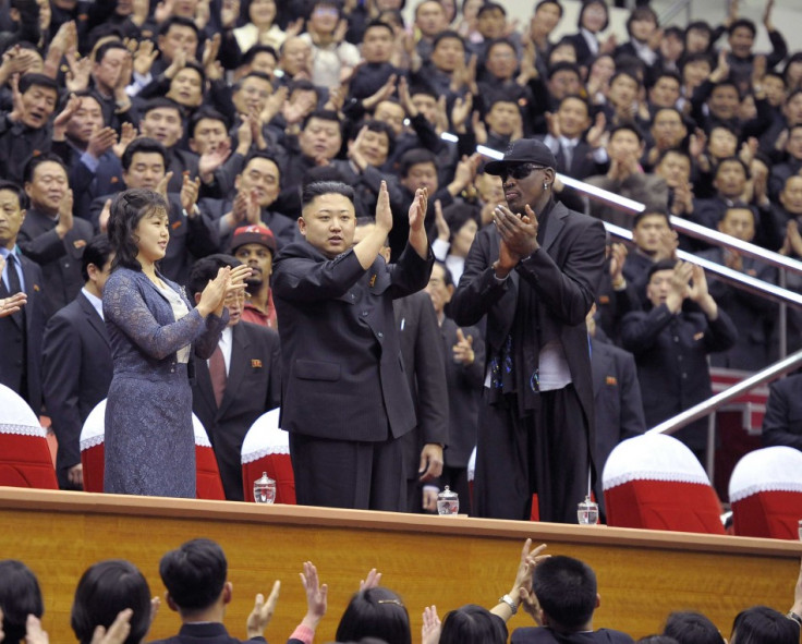North Korean leader Kim Jong-Un (C), his wife Ri Sol-Ju (L) and former NBA basketball player Dennis Rodman clap during an exhibition basketball game in Pyongyang