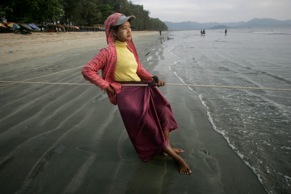 A woman pulls on a fishing net line on Maungmagan beach near the town of Dawei in southern Myanmar November 19, 2011. Picture taken November 19, 2011.