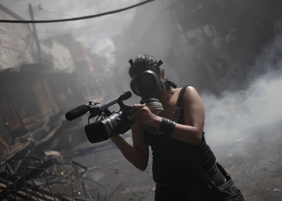 A member of the local media records a fire at the Comayaguela market in Tegucigalpa February 18, 2012.
