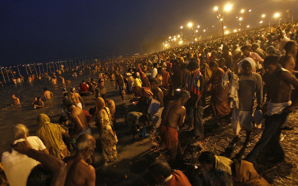 Hindu devotees gather to take a holy dip in the waters of the river Ganges during the early morning on the last bathing day of Kumbh Mela or Pitcher Festival, in the northern Indian city of Allahabad March 10, 2013. During the festival, Hindus