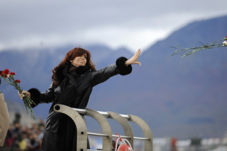 Argentine President Kirchner throws flowers into the water to pay homage to the fallen soldiers during the Falklands War in Ushuaia (Reuters)