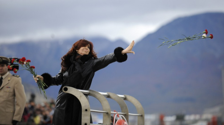 Argentine President Kirchner throws flowers into the water to pay homage to the fallen soldiers during the Falklands War in Ushuaia (Reuters)