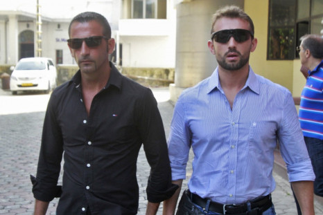 Italian sailors Salvatore Girone (R) and Massimiliano Latorre leave the police commissioner office in the southern Indian city of Koch