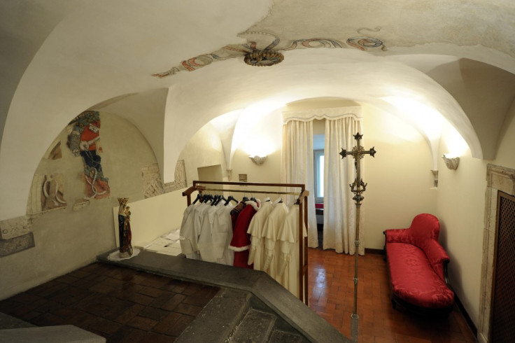 Different sizes of papal vestments hang ready for use at the Sistine Chapel in advance of the conclave, in a picture released by Osservatore Romano at the Vatican March 12, 2013. Tailors delivered three different sizes of white vestments -- small, medium