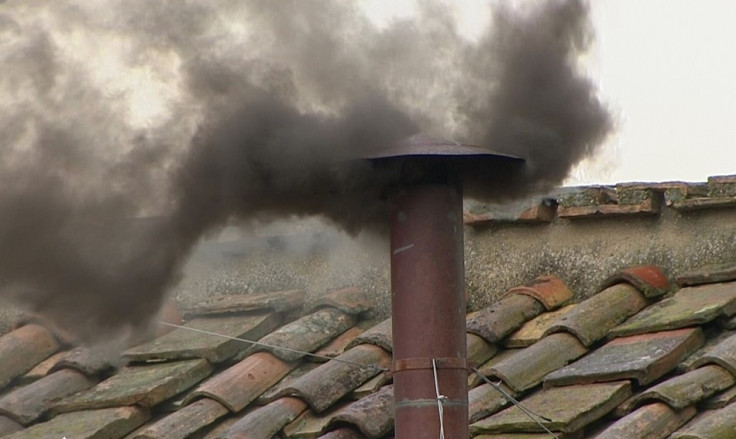 Black smoke rises from the chimney on the Sistine Chapel