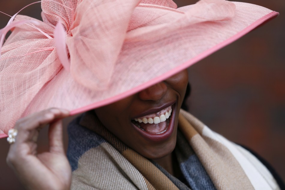 A racegoer smiles during Ladies Day, the second day of racing at the Cheltenham Festival horse racing meet in Gloucestershire, western England March 13, 2013.