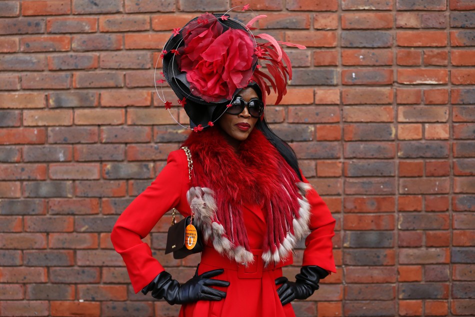 Racegoer Lystra Adams poses in her hat on Ladies Day, the second day of racing at the Cheltenham Festival horse racing meet in Gloucestershire, western England March 13, 2013.