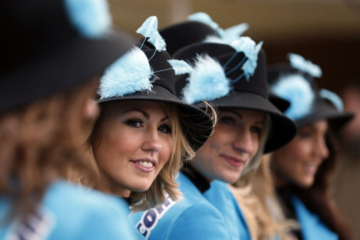 Women pose in their hats on Ladies Day, the second day of racing at the Cheltenham Festival horse racing meet in Gloucestershire, western England March 13, 2013.