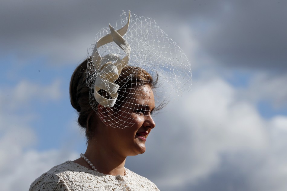 Racegoer Margaret Connolly poses in her hat on Ladies Day, the second day of racing at the Cheltenham Festival horse racing meet in Gloucestershire, western England March 13, 2013.