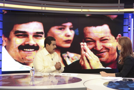 Acting Venezuelan President Nicolas Maduro (L) speaks during an interview with the news station Telesur in Caracas March