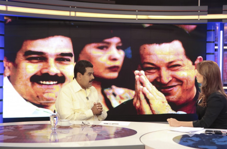Acting Venezuelan President Nicolas Maduro (L) speaks during an interview with the news station Telesur in Caracas March