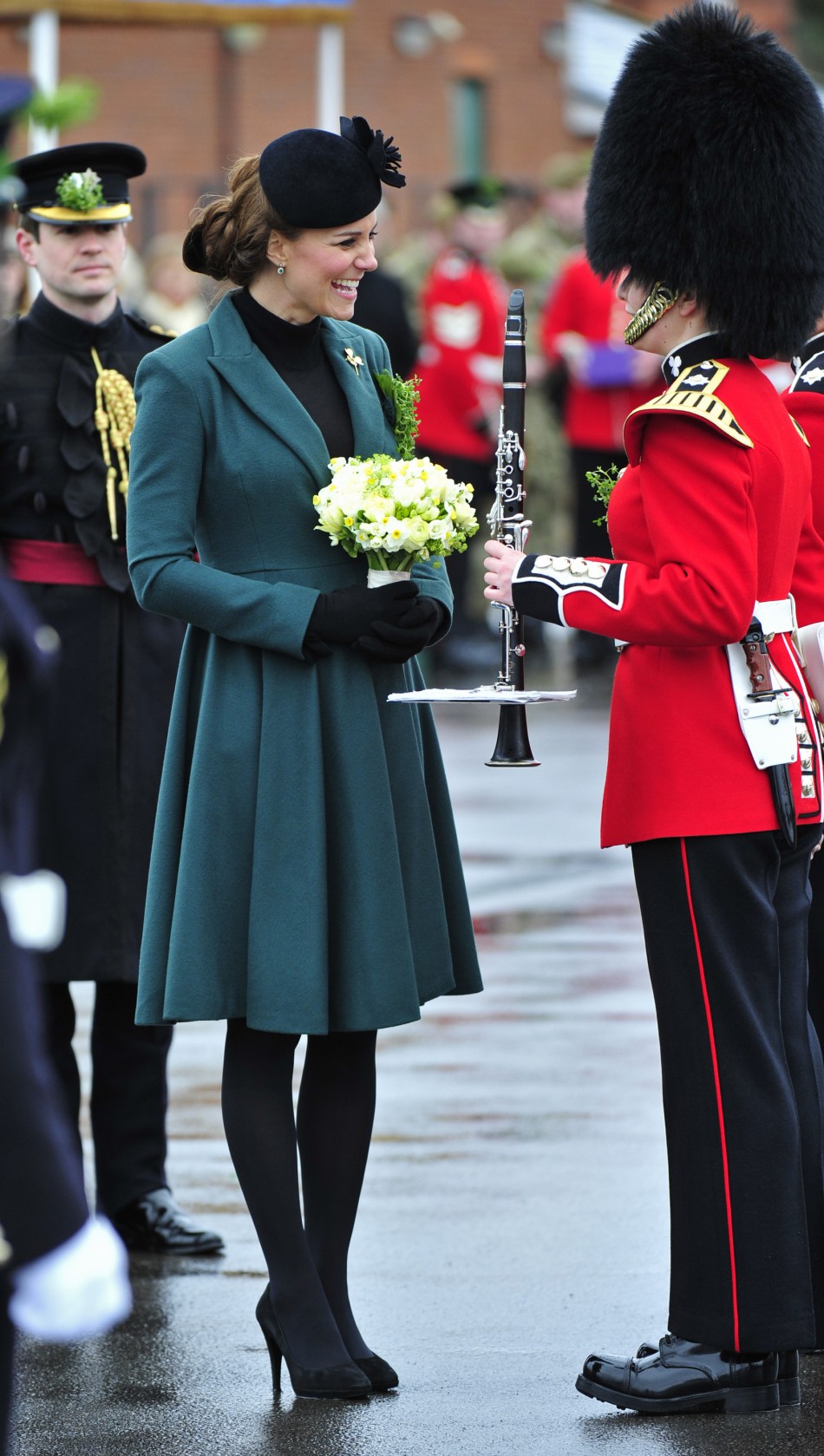 Britains Catherine, Duchess of Cambridge speaks to a soldier during a visit with her husband, Prince William, to attend a St Patricks Day Parade at Mons Barracks in Aldershot, southern England March 17, 2013. Prince William attended the Parade