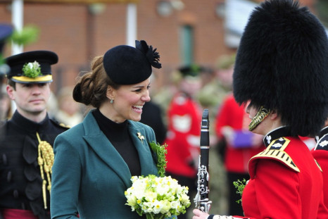 Britain's Catherine, Duchess of Cambridge speaks to a soldier during a visit with her husband, Prince William, to attend a St Patrick's Day Parade at Mons Barracks in Aldershot, southern England March 17, 2013. Prince William attended the Parade