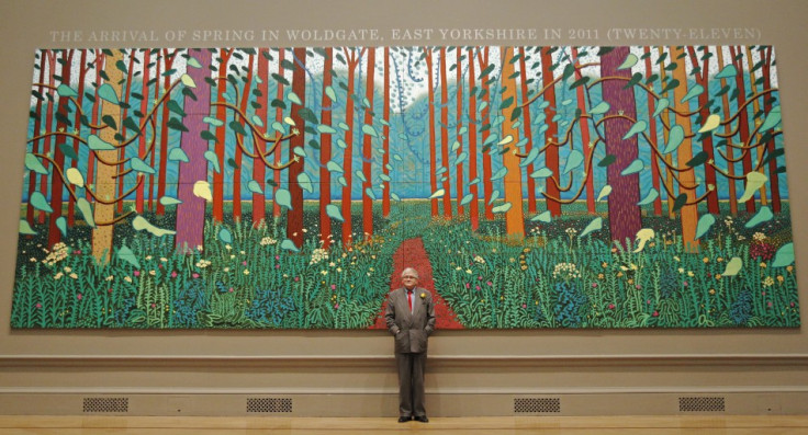 David Hockney poses with his painting "The Arrival of Spring in Woldgate, East Yorkshire in 2011 (twenty-eleven)" at the Royal Academy of Arts in London (Reuters)