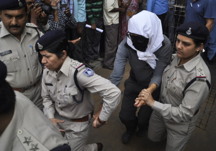 A Swiss woman with her face covered is taken to a hospital by police for her medical examination at Gwalior in the central Indian state of Madhya Pradesh March 16, 2013.